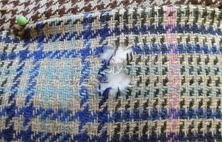 Small tear in plaid fabric before repair
