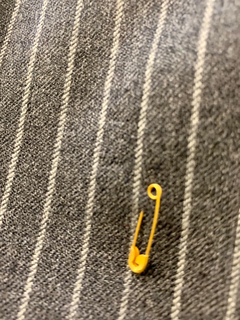 Grey pinstripe suit with moth hole